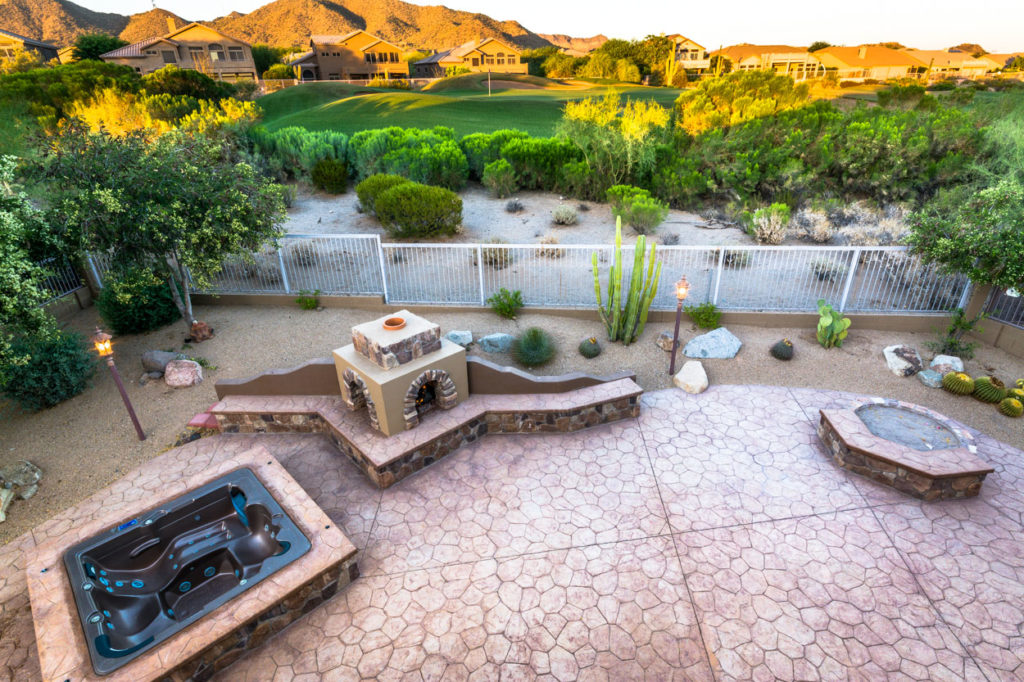 Resort-style backyard with spa and fire pit at an East Valley home