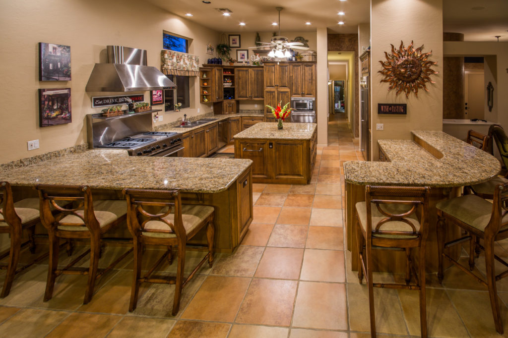 Open kitchen with granite island and breakfast bar